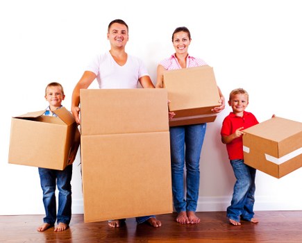 Professional movers handling desks and IT equipment in an office relocation